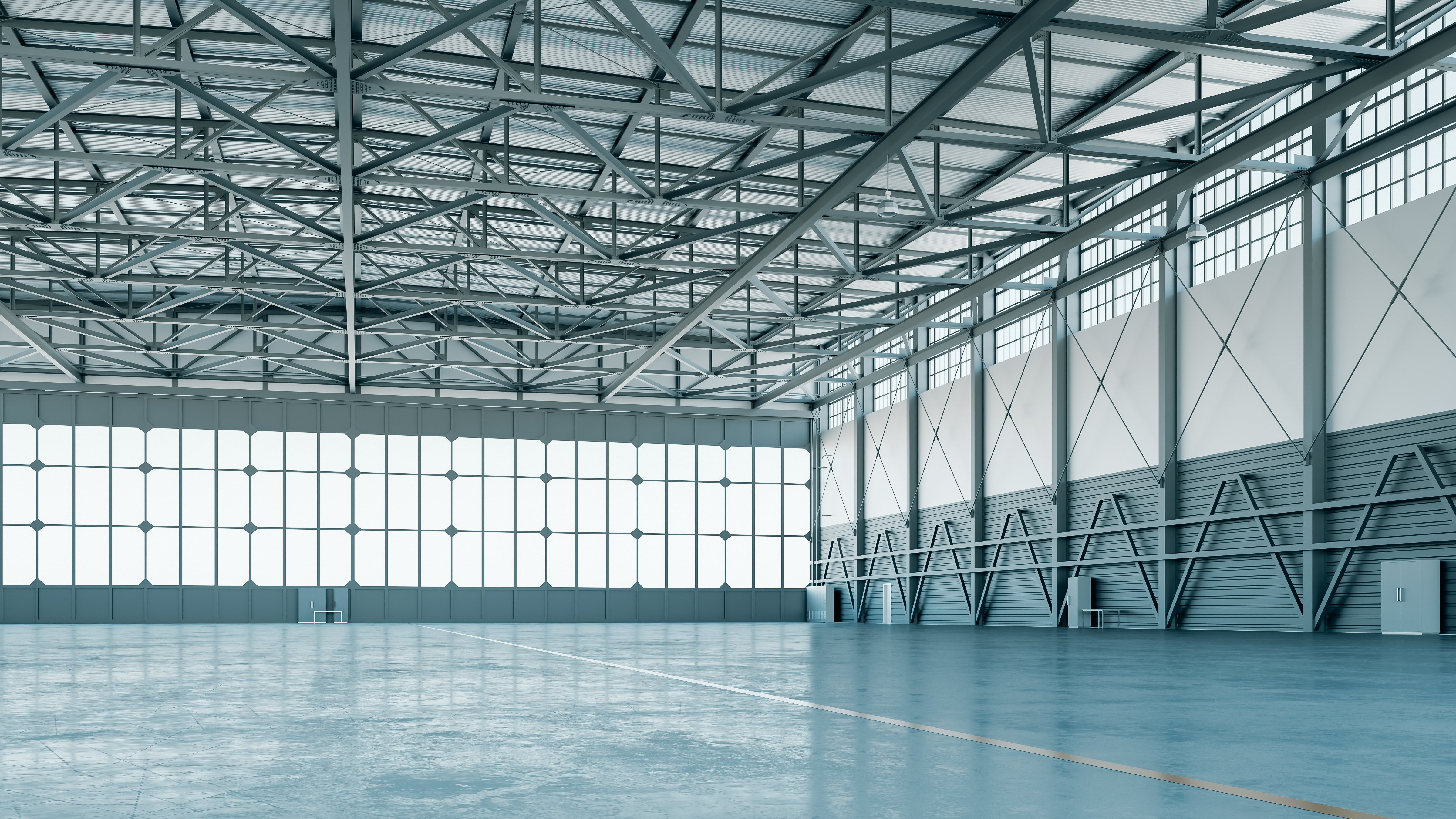 Large clear span warehouse interior with high bay lighting and polished concrete floor
